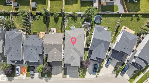Gabled roofline, attached garage, paved driveway, landscaped front yard, and fenced backyard - 22933 94A Avenue Nw, Edmonton, AB 