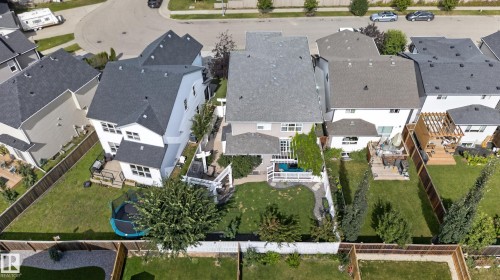 Gable rooflines and a fenced backyard with a landscaped path - 22933 94A Avenue Nw, Edmonton, AB 