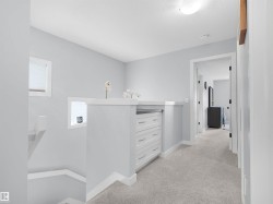 Built-in dresser with white cabinetry, polished hardware, and a durable countertop - 