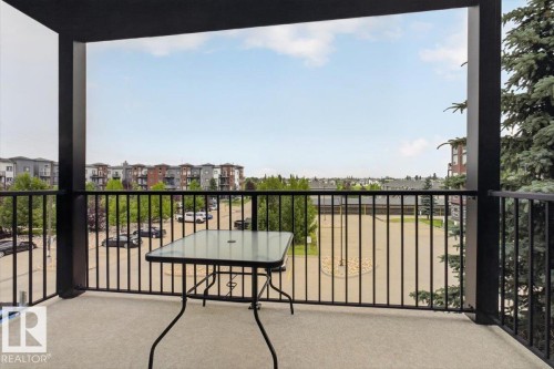 Balcony with concrete flooring and black metal railings - #316 392 Silver Berry Rd Nw, Edmonton, AB - Outdoor With Exterior