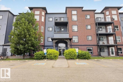 Multi-story building with a stone-clad arched entryway - #316 392 Silver Berry Rd Nw, Edmonton, AB - Outdoor With Facade