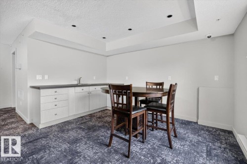 Recessed lighting illuminating a counter space with an integrated sink and base cabinetry - #316 392 Silver Berry Rd Nw, Edmonton, AB - Indoor Photo Showing Other Room
