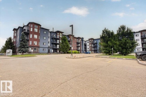 Multi-story residential building with contemporary siding and stone accents - #316 392 Silver Berry Rd Nw, Edmonton, AB - Outdoor With Facade