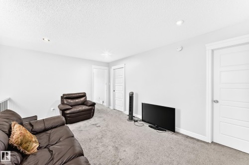 Recessed lighting, painted white walls, and a textured ceiling - 2628 Donaghey Crescent Sw, Edmonton, AB 
