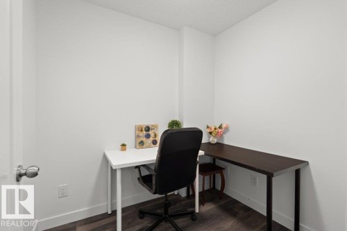 Compact room with dark wood-finish flooring, white walls, and bright white trim - 1316 Windermere Way Sw, Edmonton, AB 