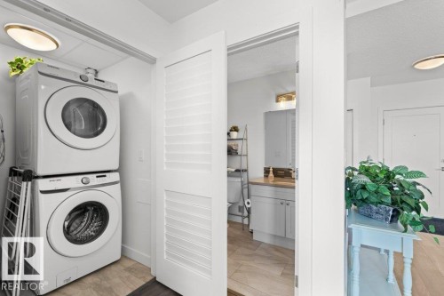 Dedicated laundry area featuring stacked front-load washer and dryer units - 1316 Windermere Way Sw, Edmonton, AB 