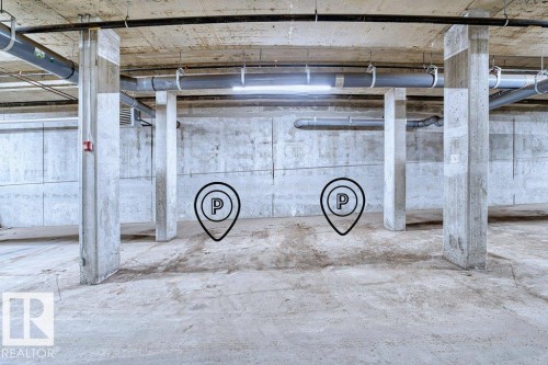 Underground parking area featuring concrete flooring and exposed concrete columns - 1316 Windermere Way Sw, Edmonton, AB 