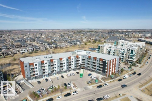 Modern multi-story residential building featuring a flat roof and multiple balconies - 1316 Windermere Way Sw, Edmonton, AB 