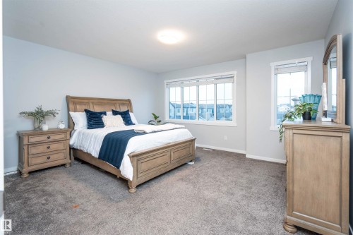 Carpeted flooring, recessed ceiling light, and multiple windows with white trim - 9232 224 St Nw Nw, Edmonton, AB 