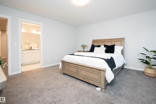 Spacious room featuring neutral carpeting and light-colored walls - 9232 224 St Nw Nw, Edmonton, AB 