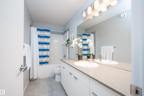 Double vanity with integrated sinks and a continuous mirror - 9232 224 St Nw Nw, Edmonton, AB 
