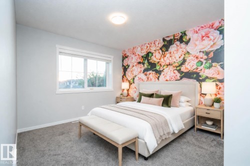 Accent wall with floral design, light gray painted walls, window with white trim,  carpet, and recessed ceiling lighting AI - 9232 224 St Nw Nw, Edmonton, AB 
