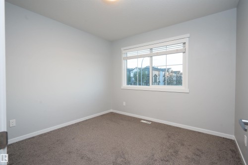 Light gray wall paint, white trim, and neutral carpet flooring - 9232 224 St Nw Nw, Edmonton, AB 