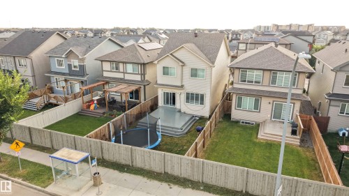 Two-story residence featuring a large rear deck and a spacious lawn - 9232 224 St Nw Nw, Edmonton, AB 