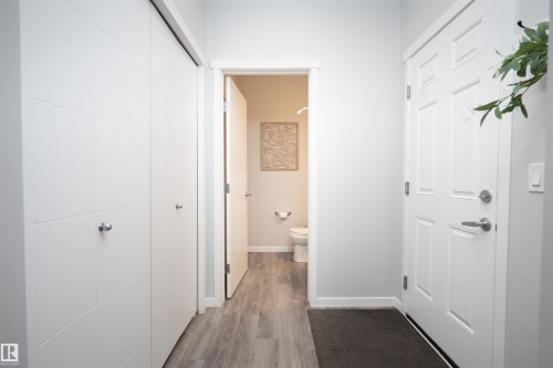 White paneled entry door with satin nickel hardware - 9232 224 St Nw Nw, Edmonton, AB 