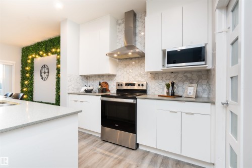 Contemporary kitchen featuring white cabinetry and light-toned countertops - 9232 224 St Nw Nw, Edmonton, AB 