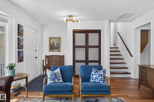 Hardwood-finish flooring, white walls, and a modern ceiling light fixture - 18316 71 Avenue Nw, Edmonton, AB 