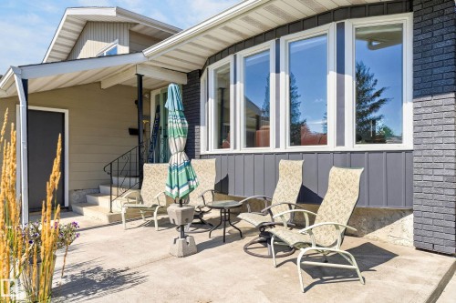 Expansive concrete patio with a brick veneer exterior - 18316 71 Avenue Nw, Edmonton, AB 
