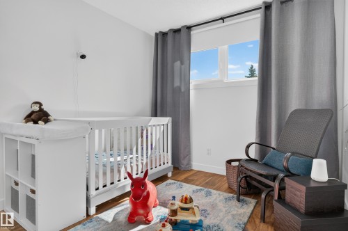 Wood-finish flooring, white walls, and a window with a roller shade - 18316 71 Avenue Nw, Edmonton, AB 