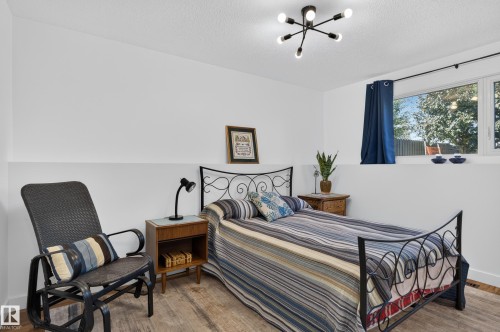 Wood-finish flooring, white walls, and a window with a dark curtain rod - 18316 71 Avenue Nw, Edmonton, AB 