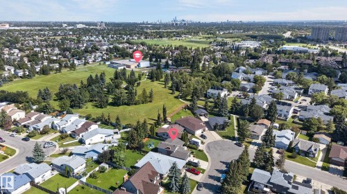 Residential neighborhood with mature trees, green spaces, and city backdrop - 18316 71 Avenue Nw, Edmonton, AB 