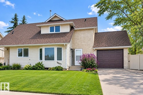 Two-story residence with a concrete driveway, attached single-car garage, and a dormer window - 9503 180A Street Nw, Edmonton, AB 