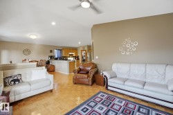 Wood-finish flooring, recessed lighting, and a ceiling fan - 