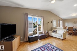 Vaulted ceilings, wood-finish flooring, and a large window with exterior access - 