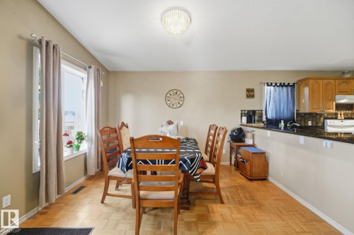 Wood-finish parquet flooring throughout, featuring a bright window with a deep sill - 5132 157 Avenue Nw, Edmonton, AB 