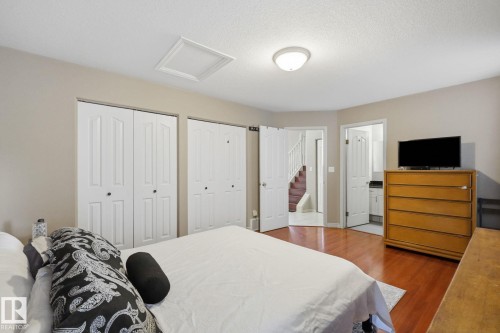 Wood-finish flooring, multiple closet doors, and recessed lighting - 5132 157 Avenue Nw, Edmonton, AB 