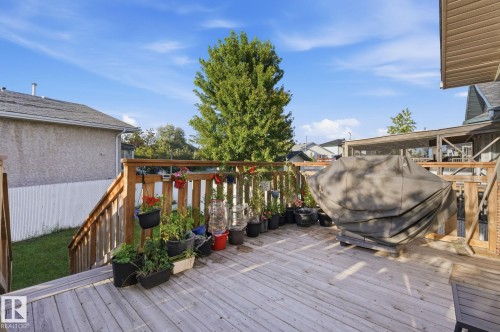 Expansive wood deck with natural wood railings, providing an outdoor living area - 5132 157 Avenue Nw, Edmonton, AB 