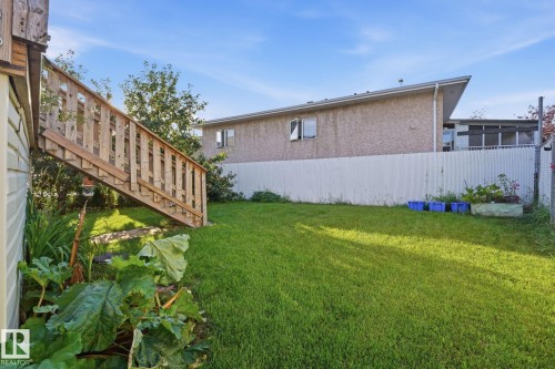 Expansive grassy yard with a permanent wooden staircase - 5132 157 Avenue Nw, Edmonton, AB 