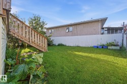 Expansive grassy yard with a permanent wooden staircase - 