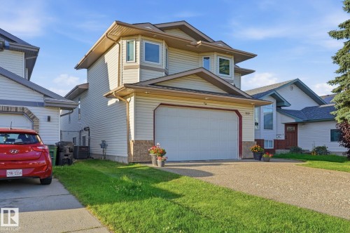 Two-story residence featuring light-colored siding and a two-car garage - 5132 157 Avenue Nw, Edmonton, AB 