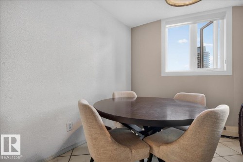 Bright interior space featuring a window with white trim, light-toned walls, and tile flooring - #1102 9916 113 St Nw, Edmonton, AB 