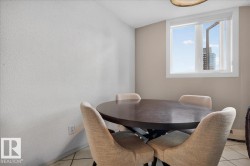 Bright interior space featuring a window with white trim, light-toned walls, and tile flooring - 