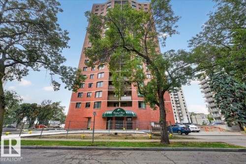 Brick exterior high-rise building with a green awning entrance - #1102 9916 113 St Nw, Edmonton, AB 