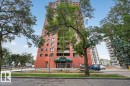 Brick exterior high-rise building with a green awning entrance - #1102 9916 113 St Nw, Edmonton, AB 