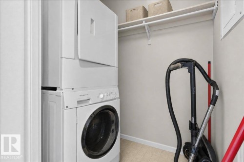 Stackable washer and dryer, built-in shelving, and light-toned wall paint - #1102 9916 113 St Nw, Edmonton, AB 