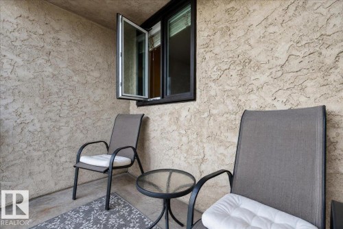 Textured stucco wall finish with an operable casement window - #1102 9916 113 St Nw, Edmonton, AB 
