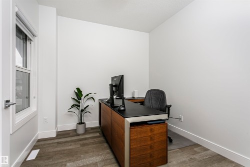 Wood-finish flooring with crisp white walls and white trim - 9107 181 Avenue Nw, Edmonton, AB 