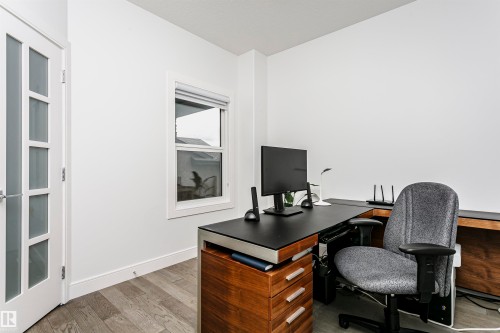 Wood-finish flooring, white walls, frosted glass panel door, and a single window - 9107 181 Avenue Nw, Edmonton, AB 