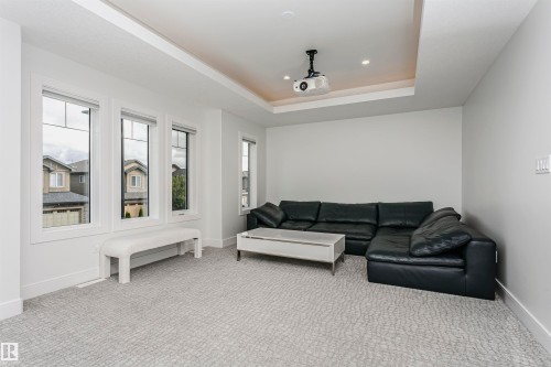 Recessed lighting, tray ceiling, integrated projector, and three large windows - 9107 181 Avenue Nw, Edmonton, AB 