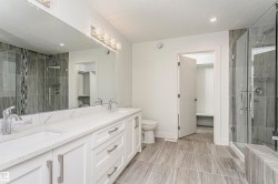Dual vanity with undermount sinks and white countertops - 