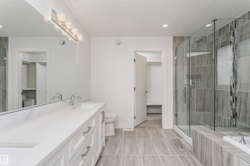 Dual vanity with white cabinetry and a light-colored countertop - 9107 181 Avenue Nw, Edmonton, AB 
