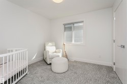 White walls with a single window featuring a roller shade - 