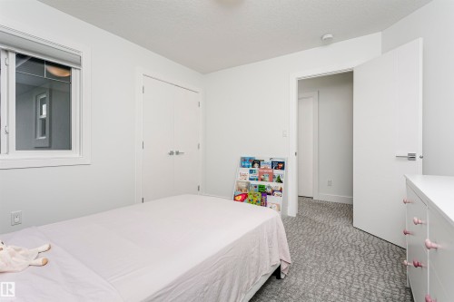 White interior walls, white trim, white window frame, and patterned carpet flooring - 9107 181 Avenue Nw, Edmonton, AB 