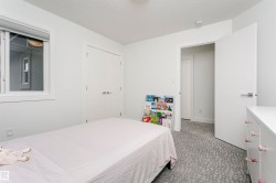 White interior walls, white trim, white window frame, and patterned carpet flooring - 