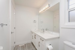 Dual vanity with white cabinetry, polished chrome hardware, and undermount sinks - 