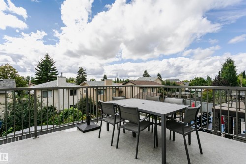 Expansive outdoor terrace featuring a gray textured surface and dark metal railings - 9107 181 Avenue Nw, Edmonton, AB 